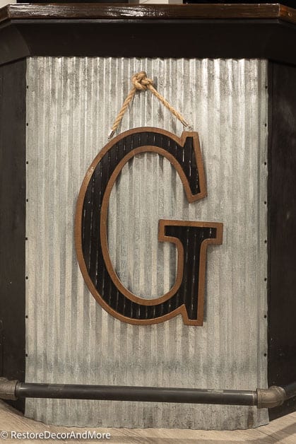Corrugated metal bar front with the letter G Sign