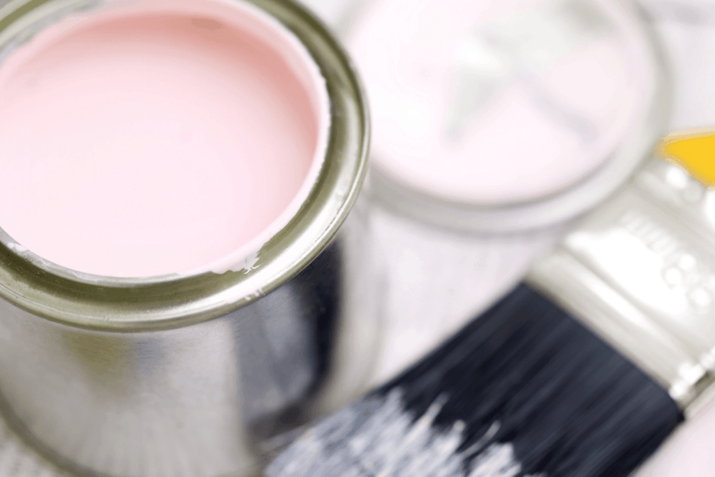 pink paint in can and brush