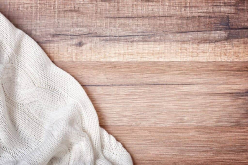 White knit blanket on wood background