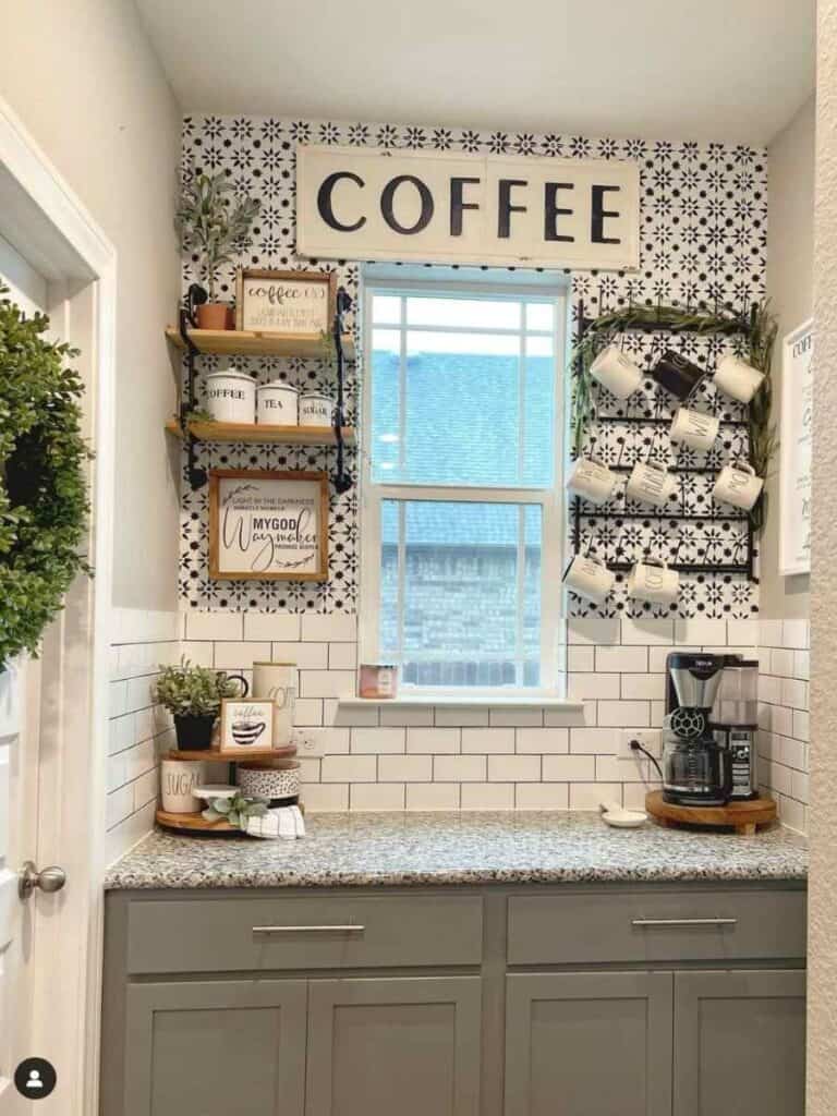 coffee bar nook on counter with window in middle, mug rack on side and large coffee sign,