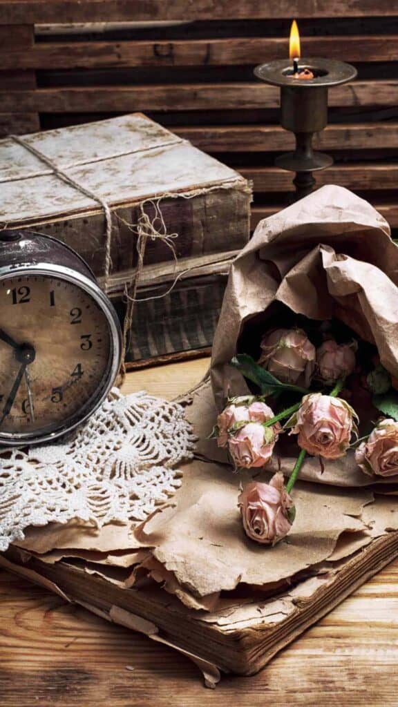 vintage aesthetic wallpaper iPhone flowers, old clock, old books, old candle
