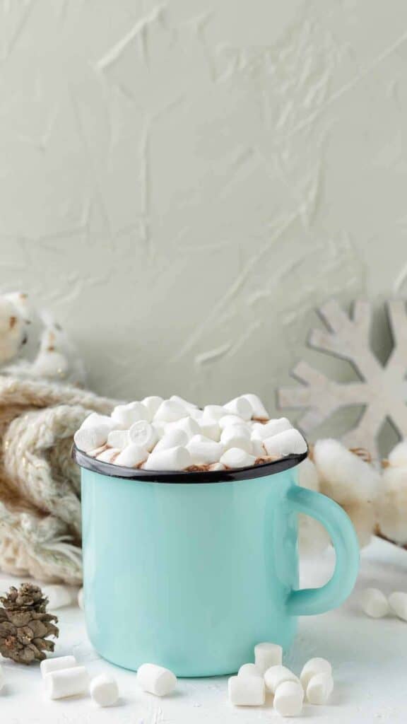aesthetic cute winter wallpaper teal cup filled with hot cocoa and marshmallows