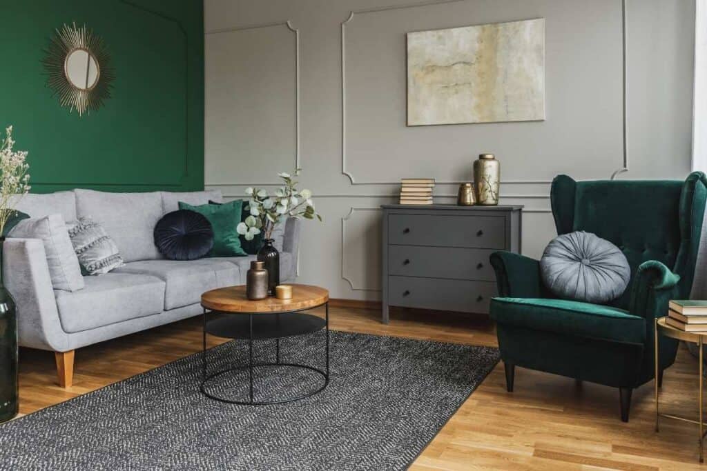 emerald green accent chair, emerald green wall, grey furniture, gray rug