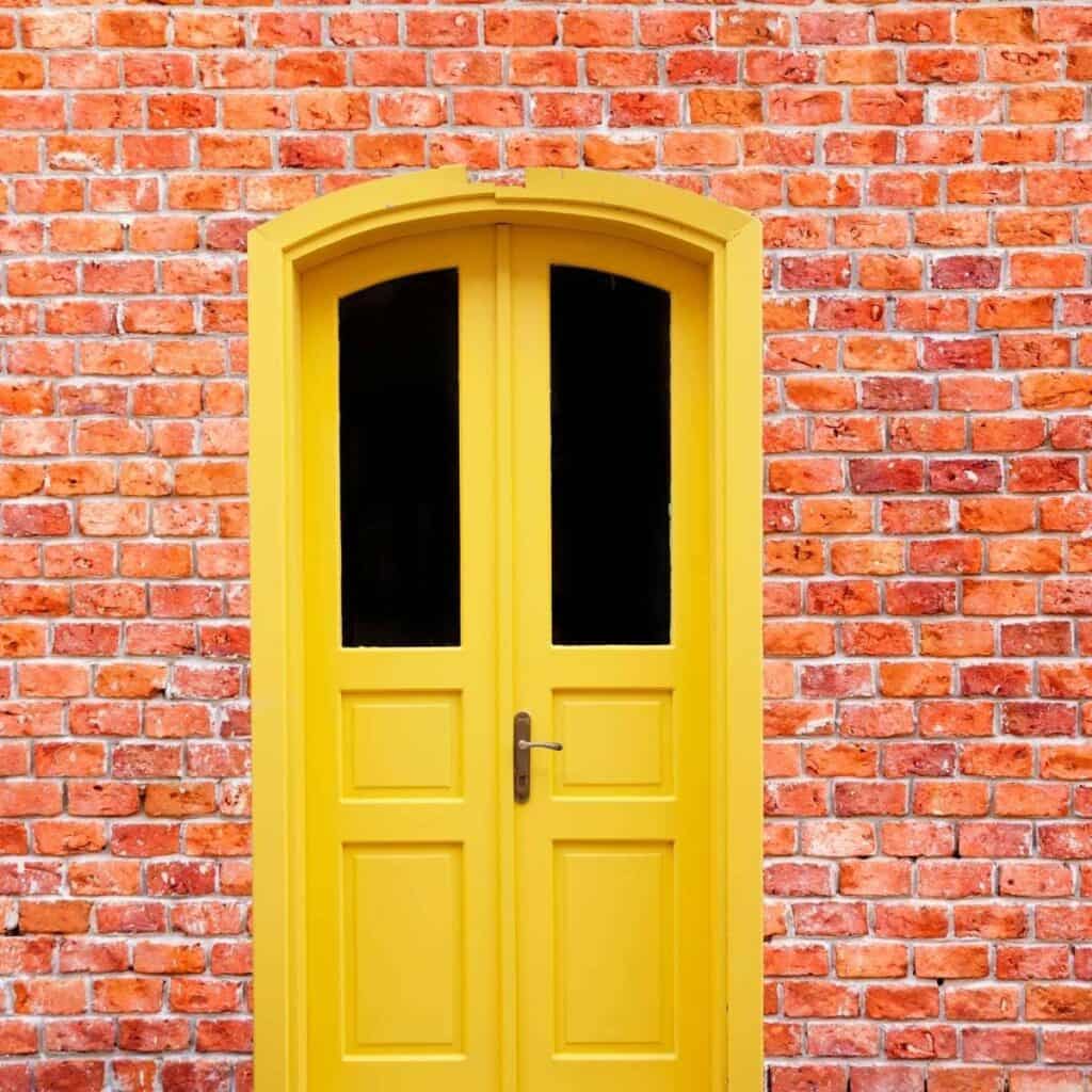red brick house yellow door