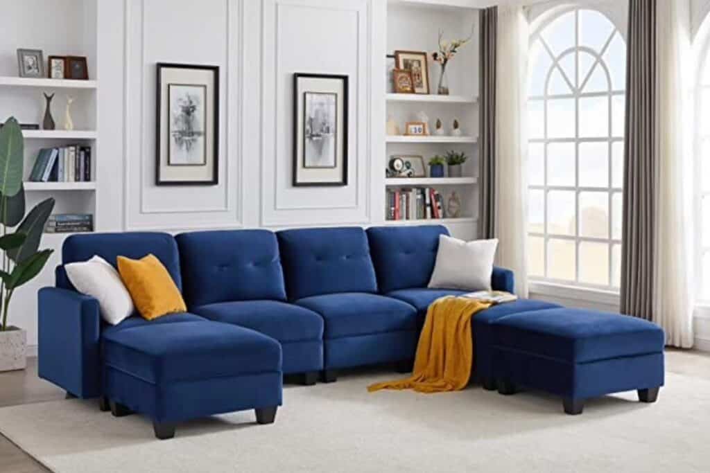 navy blue sofa with mustard yellow pillow and blanket