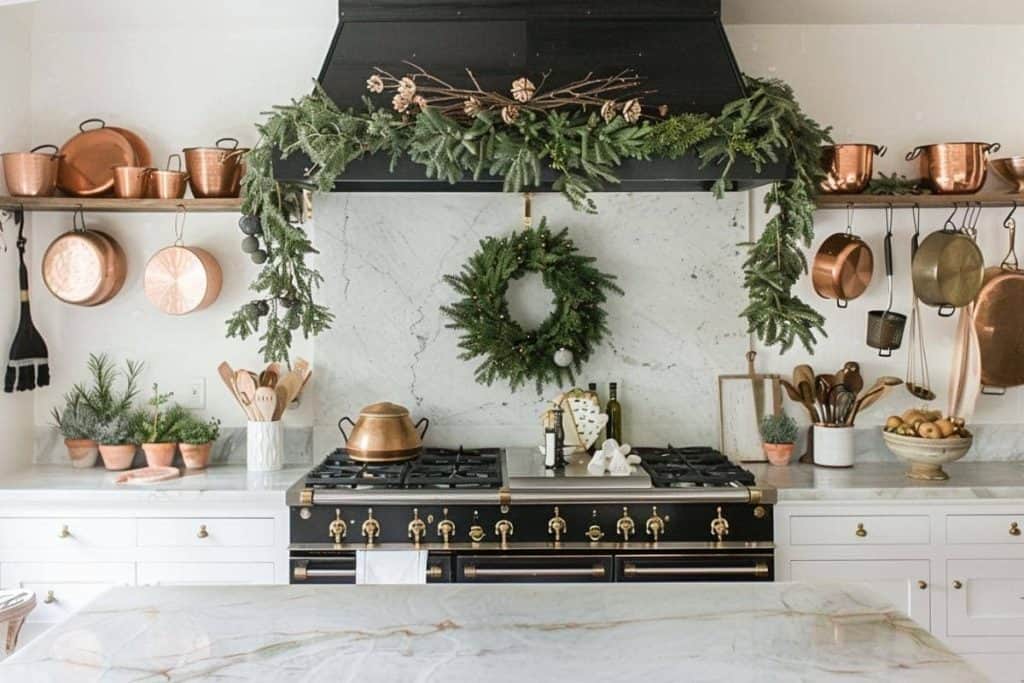 A farmhouse kitchen blending rustic charm with Christmas festivity, featuring copper accents, a garland-wrapped range hood, and a welcoming atmosphere