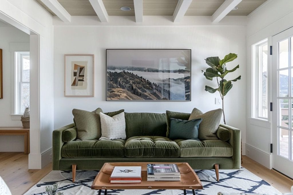 Elegant living room with a green velvet sofa and a rustic wooden coffee table. The room includes a large woven rug, various decorative pillows, and a striking black and white framed artwork, creating a sophisticated and comfortable ambiance.